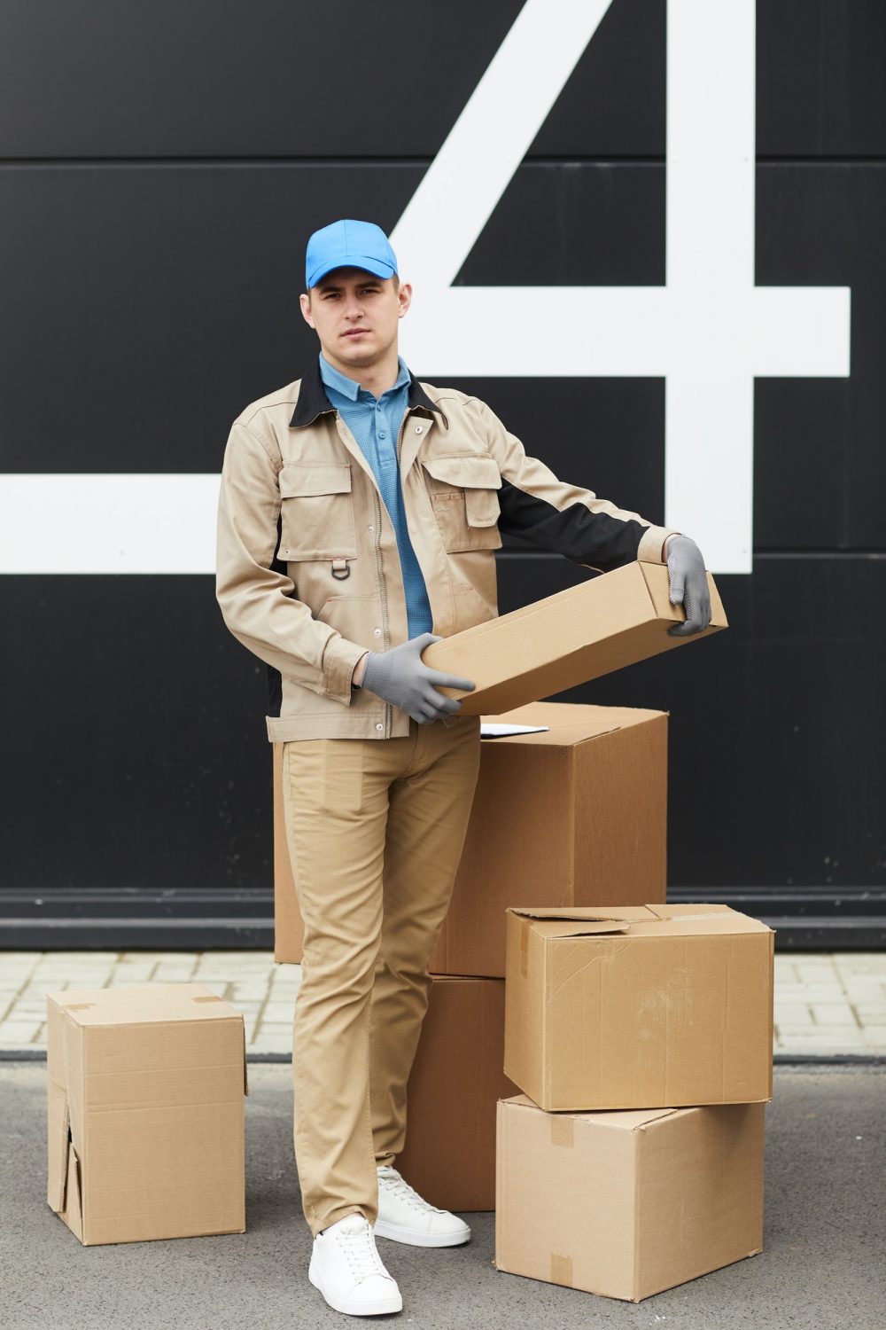 Courier working with parcels in warehouse
